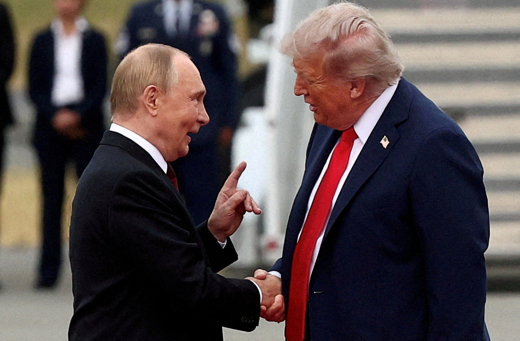 Donald Trump shakes hand with Russian president Vladimir Putin at Joint Base Elmendorf-Richardson in Anchorage