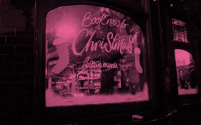 The window of a pub advertising a Christmas festive menu.