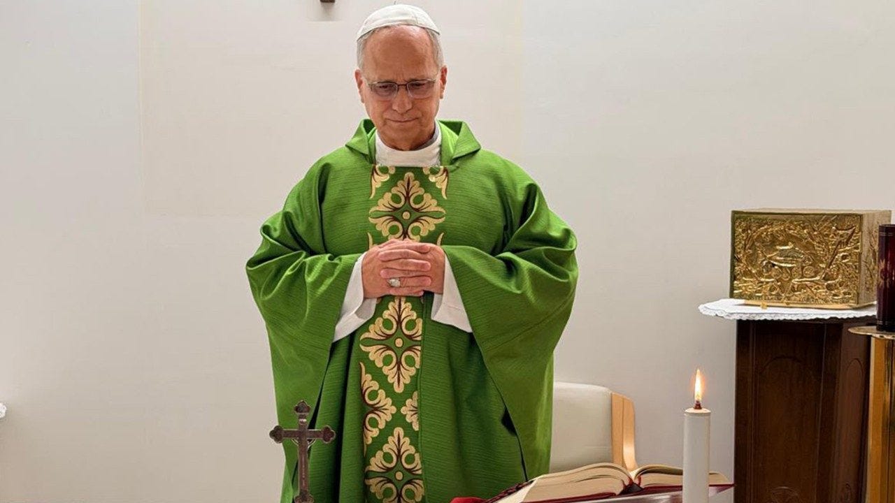 Pope Leo XIV, in green vestments, stands at the altar with hands folded in a hospital chapel at Gemelli