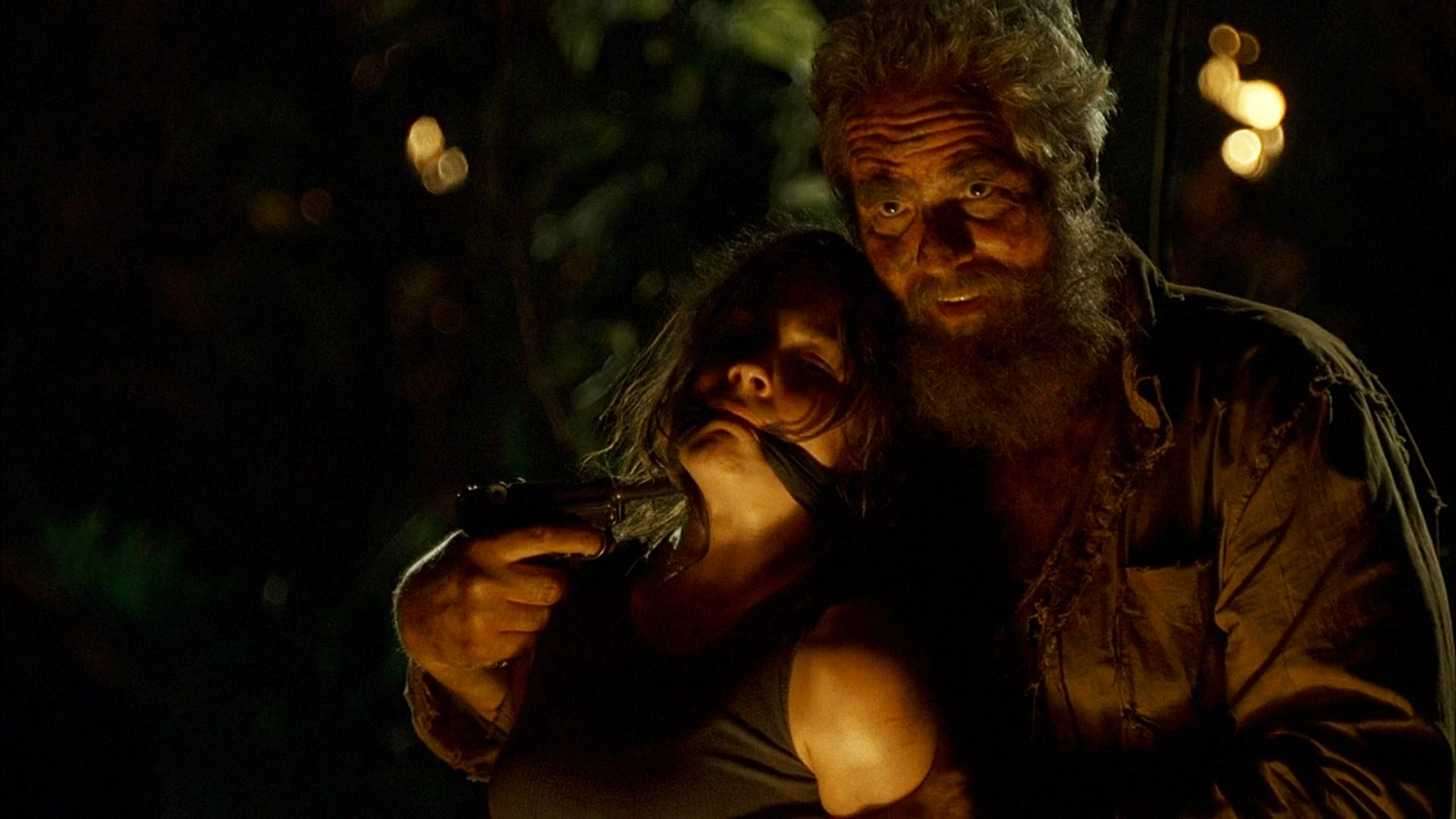 Tom (MC Gainy) holds Kate (Evangeline Lily) at gunpoint.