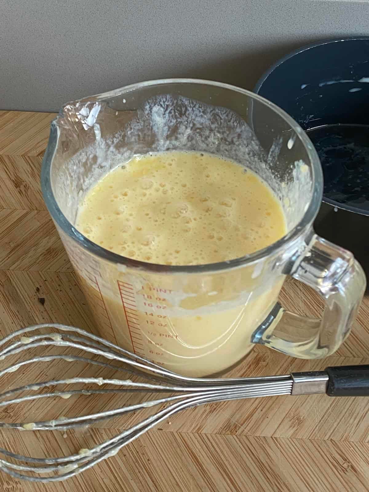 Jug of melted butter, eggs and buttermilk. Jug of melted butter, eggs and buttermilk.