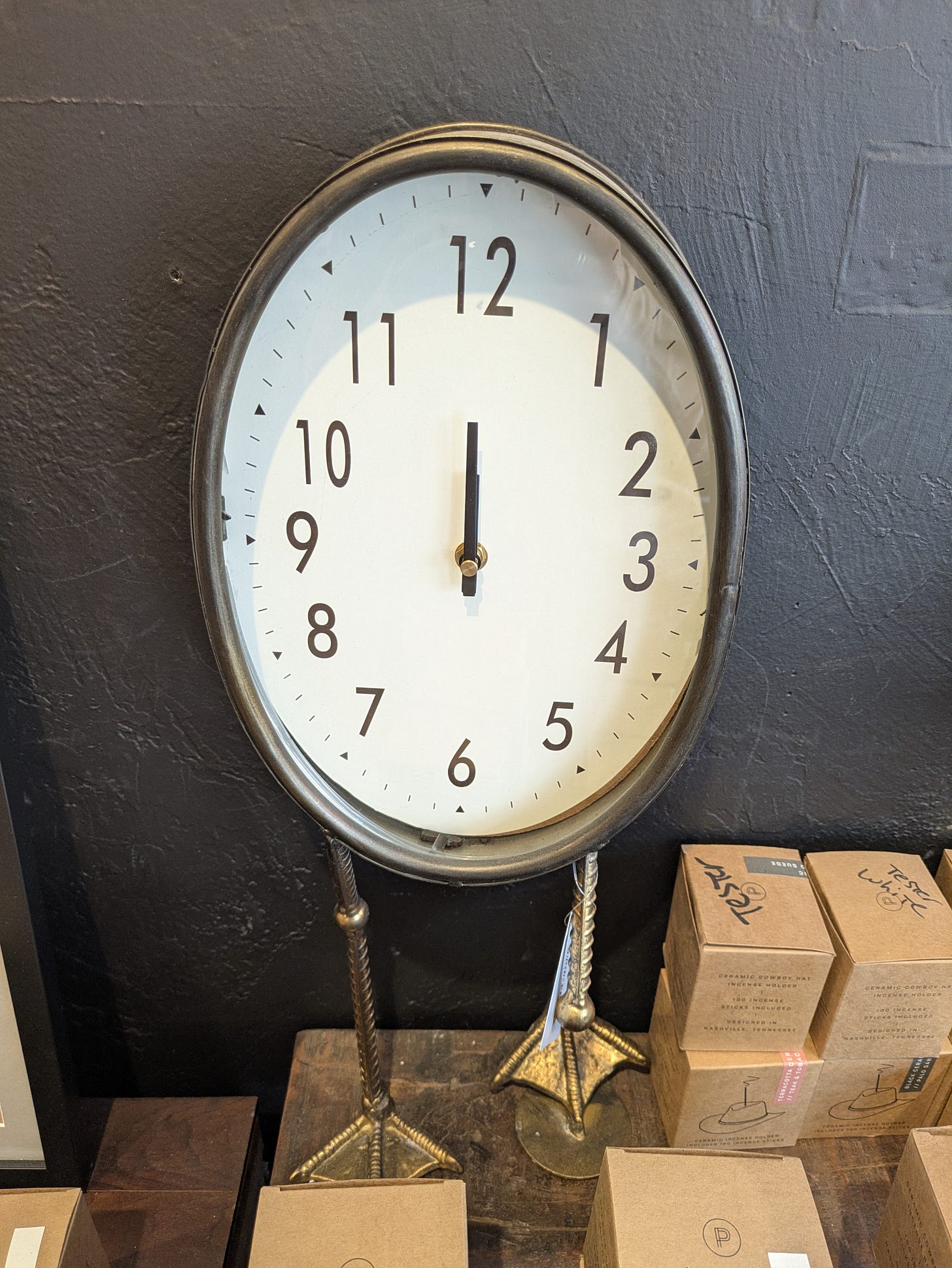 A clock with duck feet and long legs, standing in a store