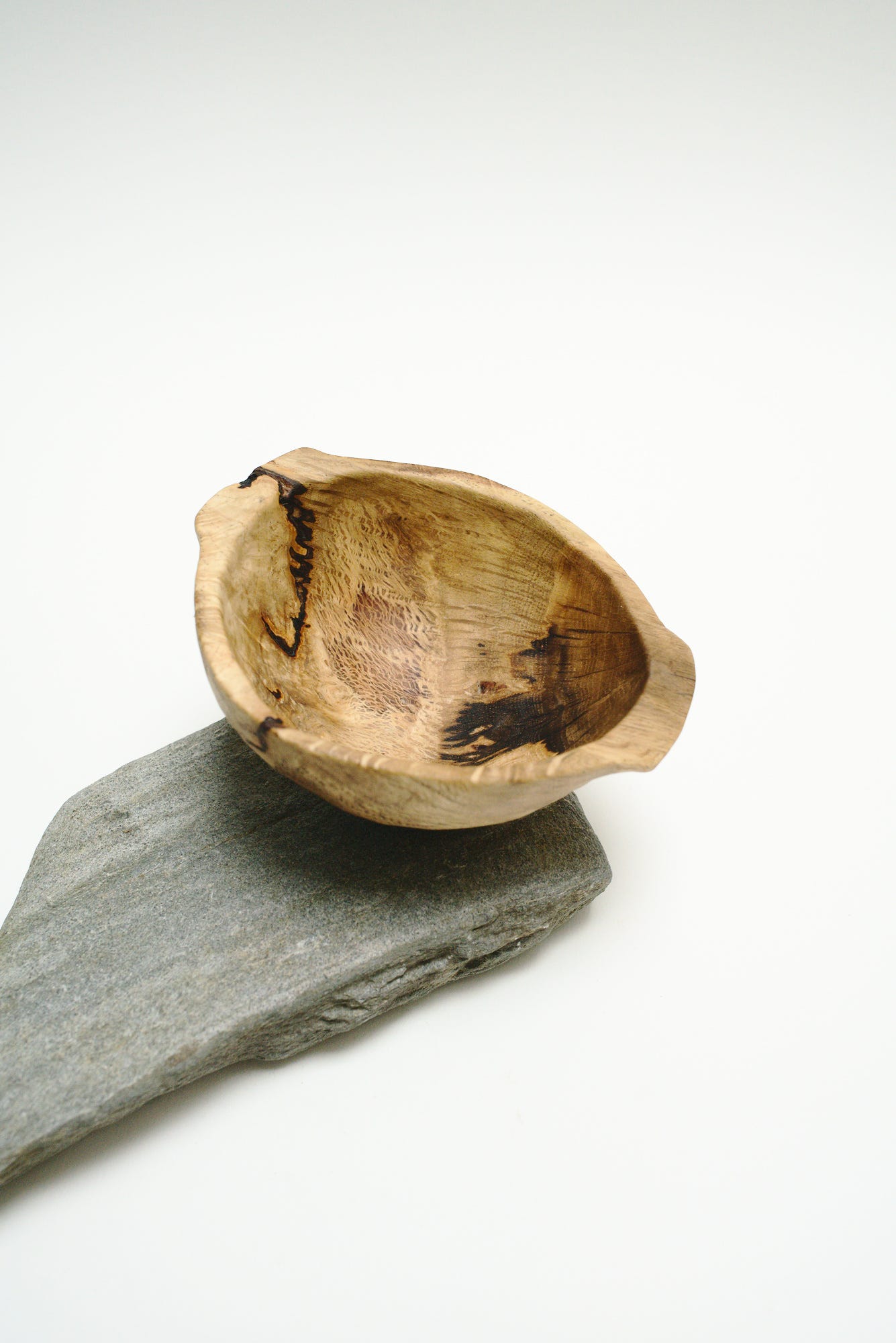 A traditional scottish quaich that I carved from a thrown away oak burl. In the wood you can see unbelievable patterns that might remind you of the universe or rivers.