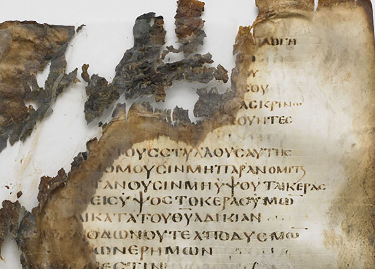 Ancient charred manuscript with Greek text on it Ancient charred manuscript with Greek text on it