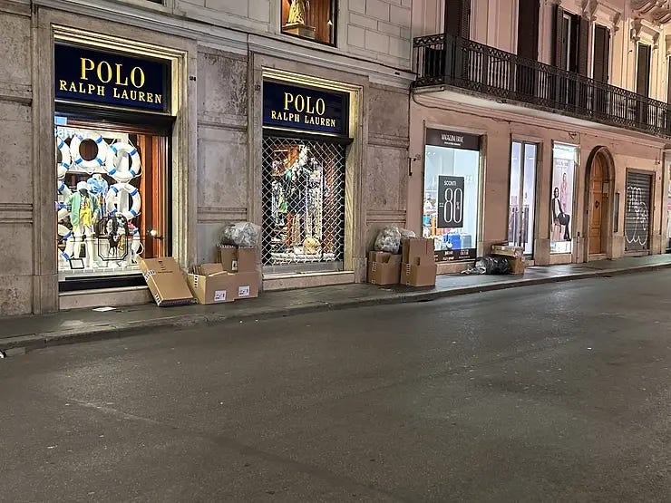 Cardboard boxes piled outside shops on Via del Corso, Rome. Cardboard boxes piled outside shops on Via del Corso, Rome.