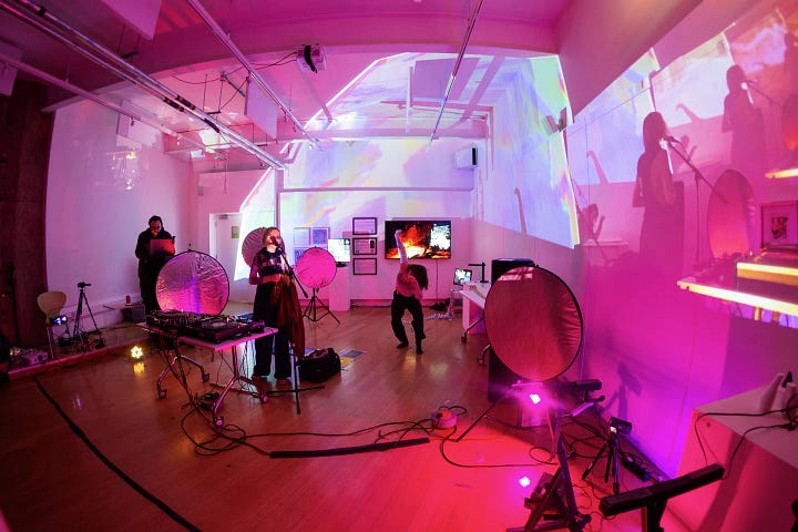 Images of artists working with computers and projectors in an art gallery
