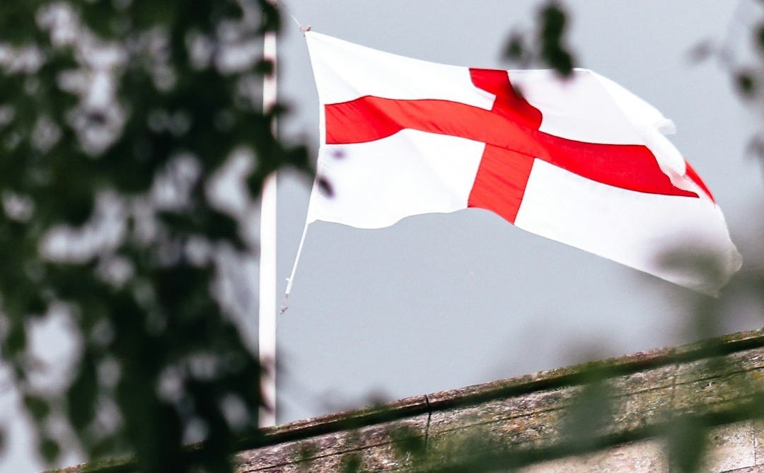 a flag flying on top of a brick building