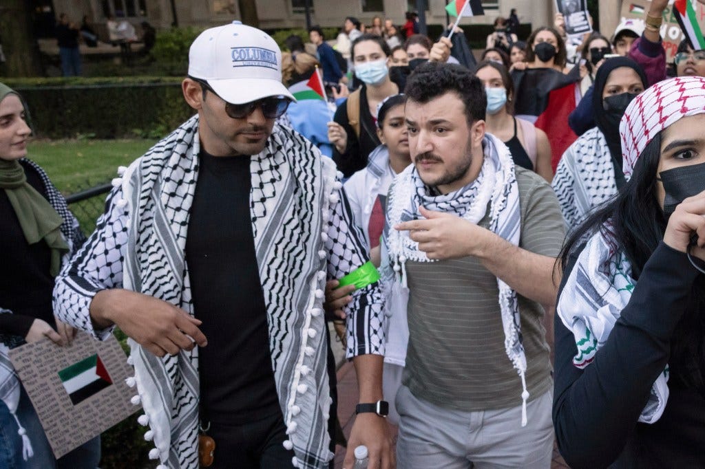 Mahdawi with his friend and fellow Palestinian activist Mahmoud Khalil at a Columbia protest on Oct. 12, 2023.