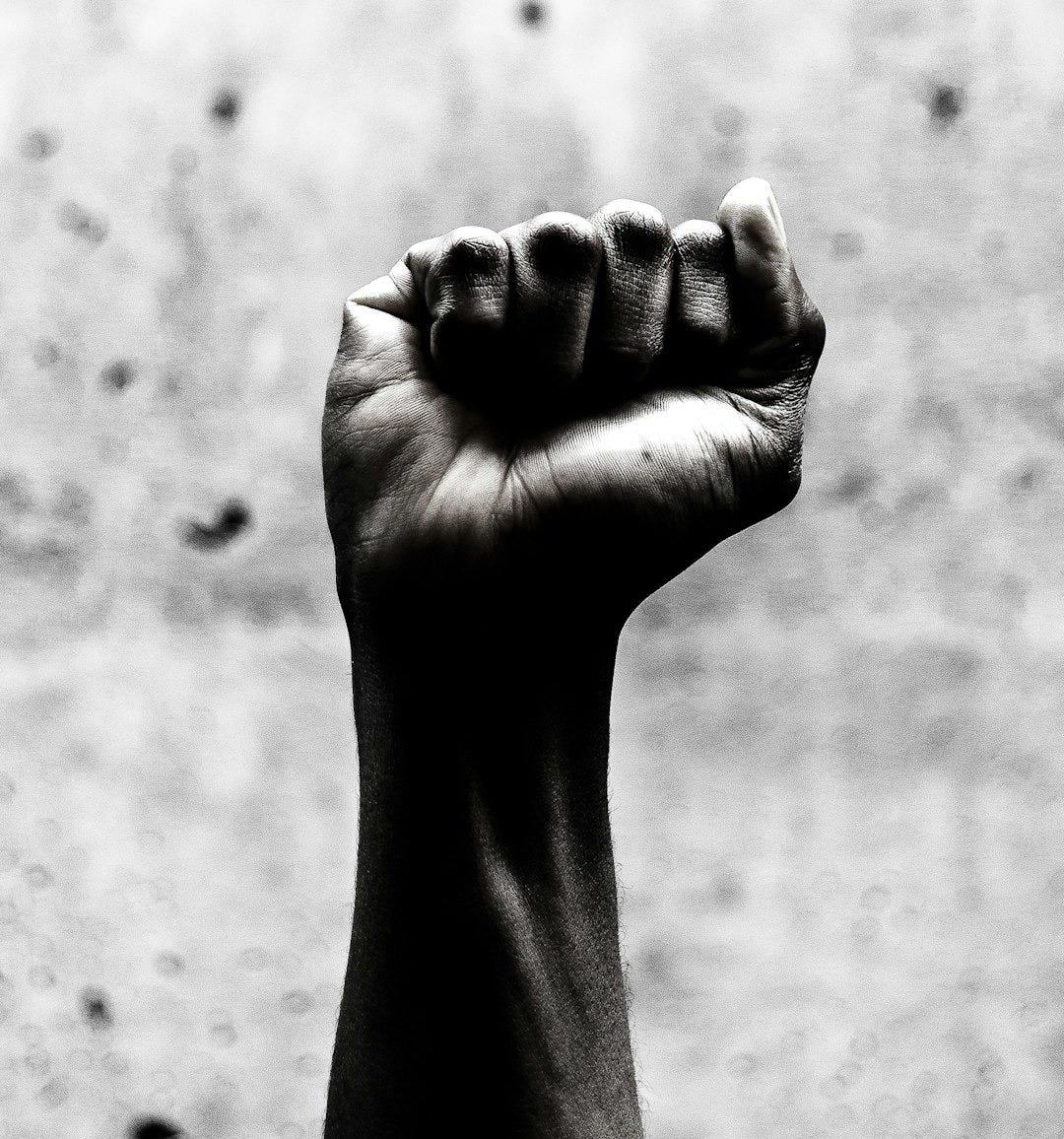 person's right fist grayscale photography
