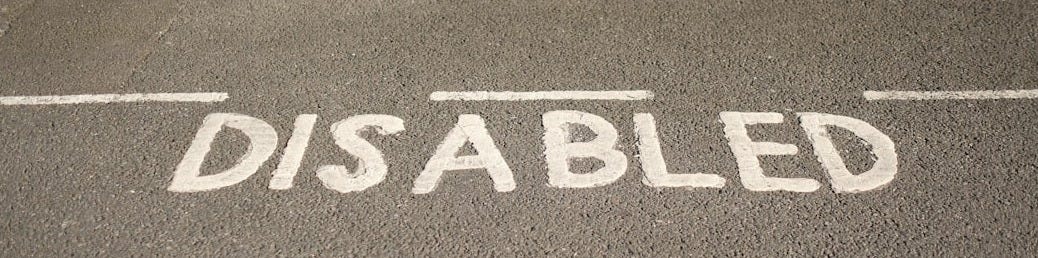 A street sign that reads disabled on the side of the road