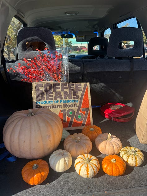two pictures with a trunk full of different pumpkins, seventeen total. Another picture of a piano-altar, with Andrea's photos, autumnal garland, and pumpkins.