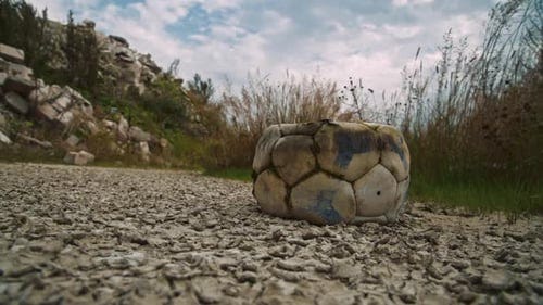 Deflated old football lying on the ground. Aged and useless soccer ball  thrown out, Industrial Stock Footage ft. deflated & football - Envato