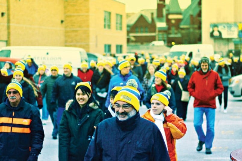 Group of people walking in the cold in support of homeless initiatives