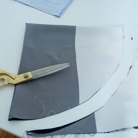 cutting a circle shape from a square piece of fabric with golden shea cutting a circle shape from a square piece of fabric with golden shea
