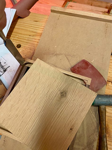 Using a mortising bit to cut a groove for the base to sit into.
