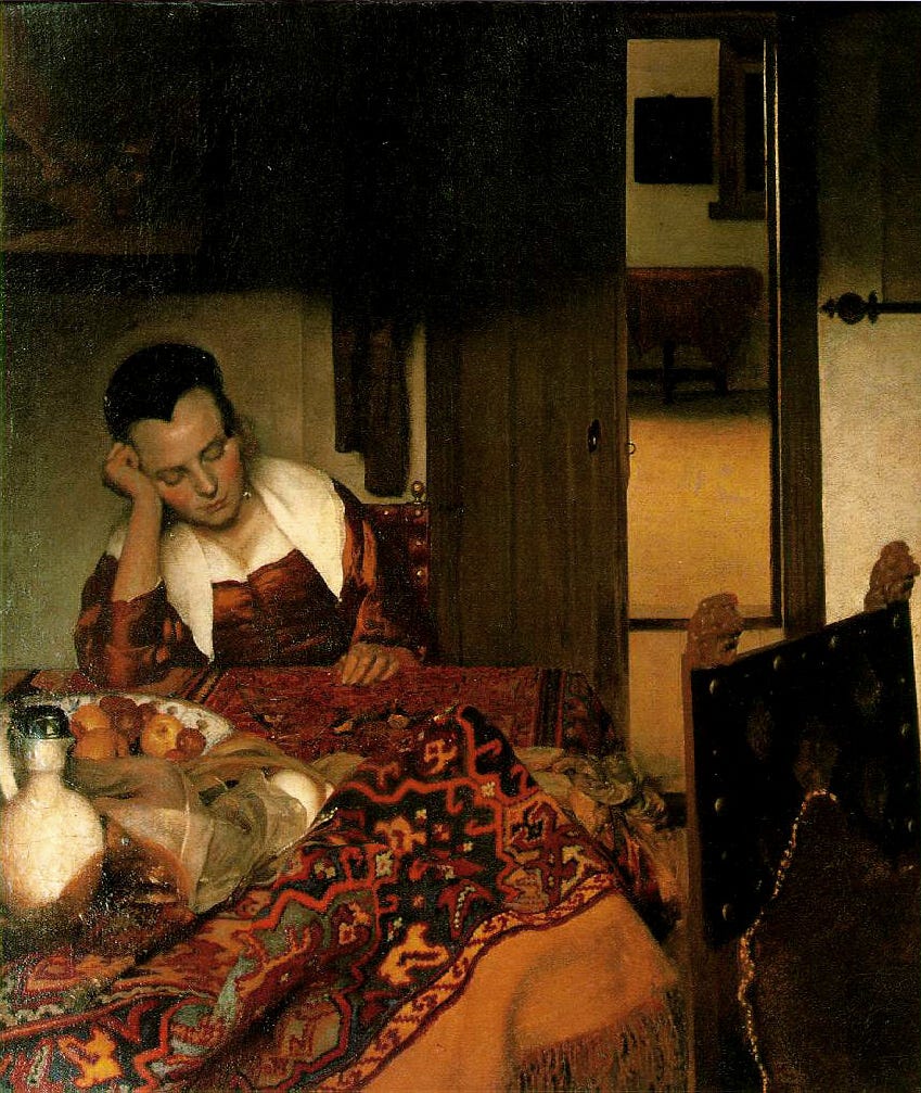 A young woman asleep at a table with a glass of wine A young woman asleep at a table with a glass of wine