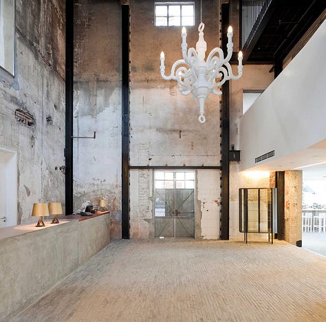 Neri&Hu — The Waterhouse at South Bund, Shanghai. Former 1930s Japanese army headquarters converted into a boutique hotel. Raw concrete, preserved industrial structure, and original markings held deliberately as identity rather than erased.