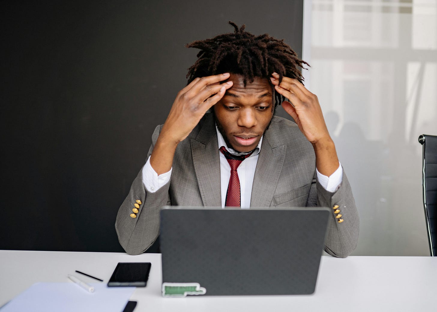 A Frustrated Businessman in Front of a Laptop · Free Stock Photo