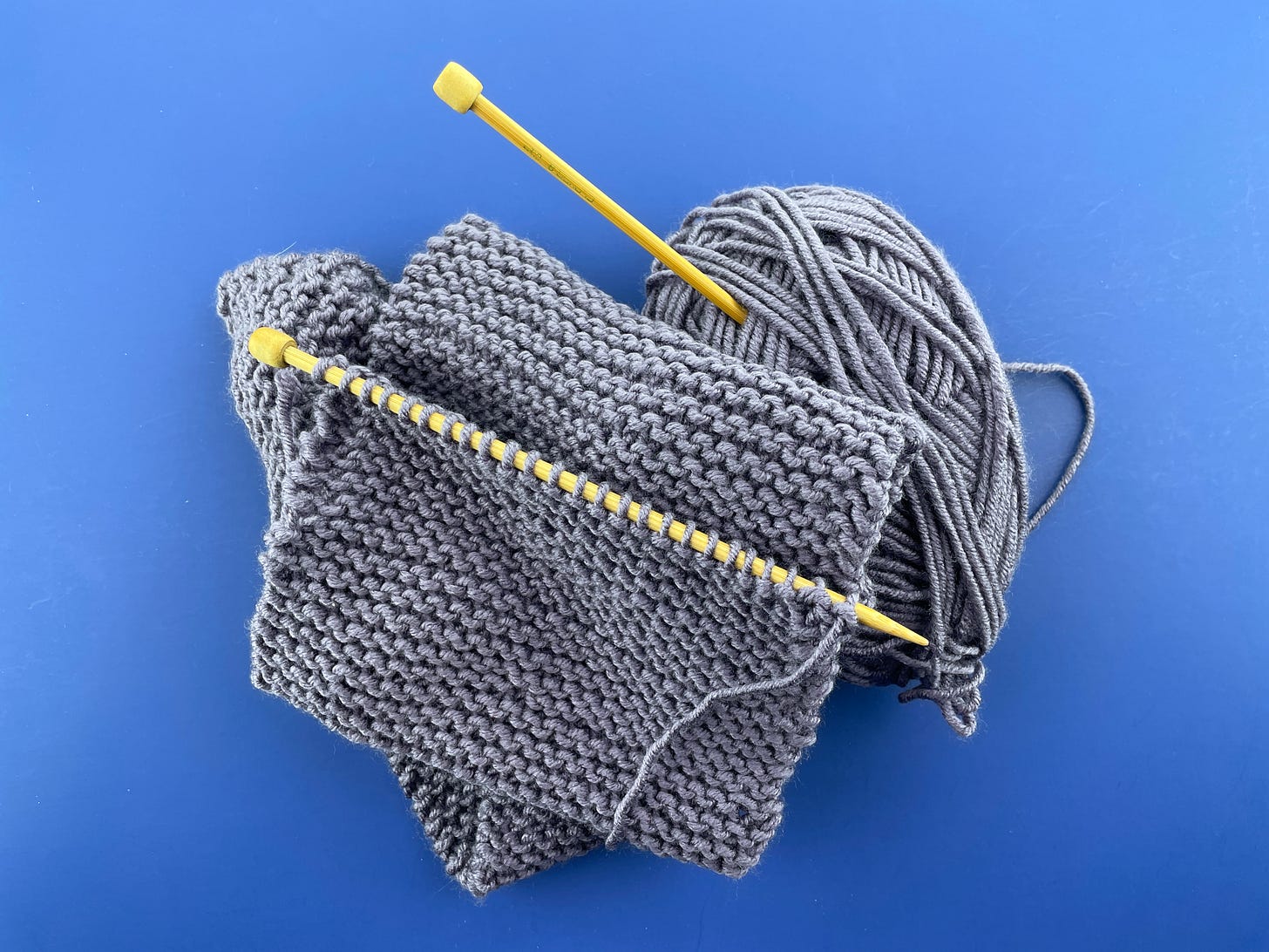 A very simple, partially-knitted garter stitch scarf.