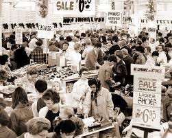 A black and white photo of a busy department store.