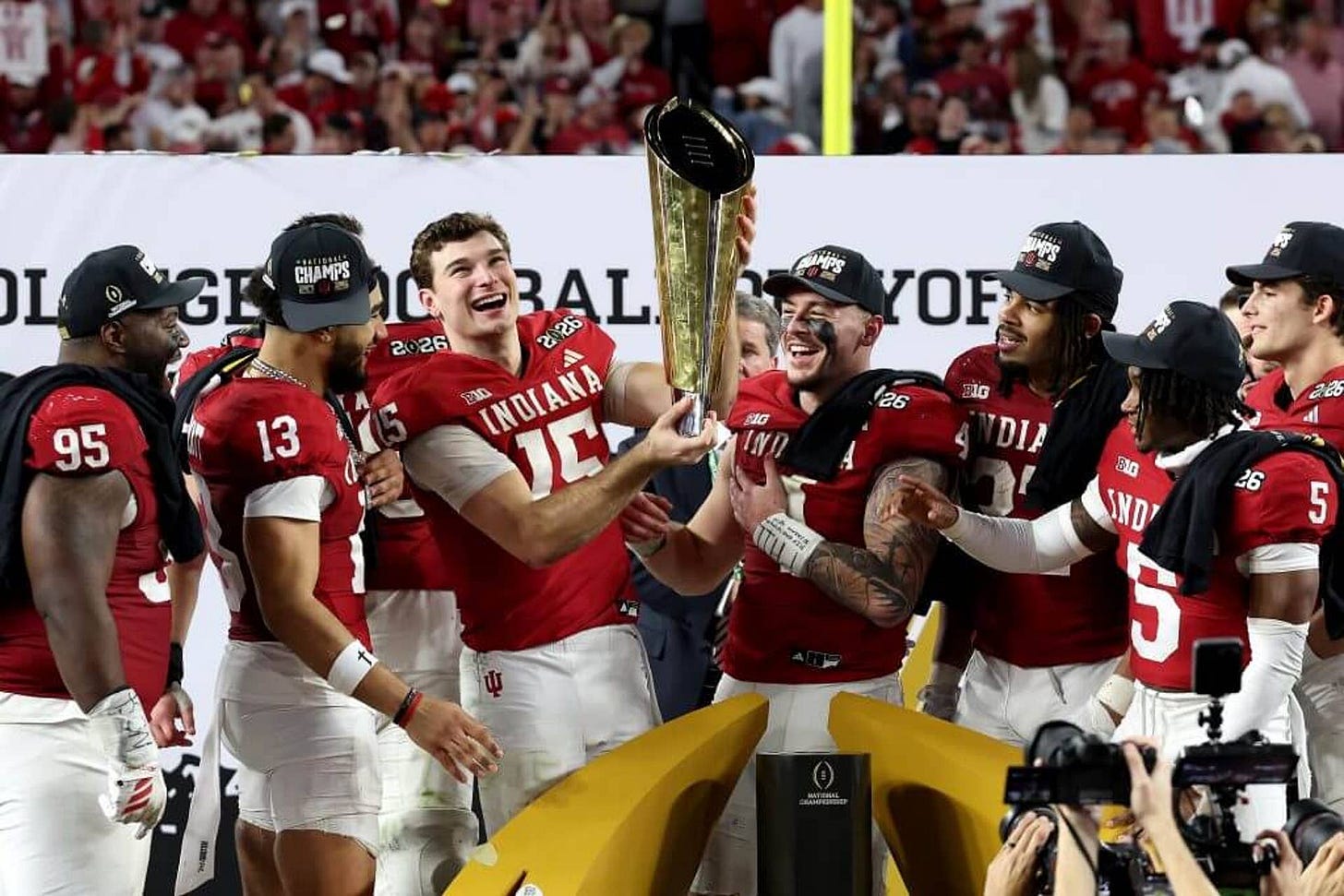 The Indiana Hoosiers hold the championship trophy on the field at Hard Rock Stadium The Indiana Hoosiers hold the championship trophy on the field at Hard Rock Stadium