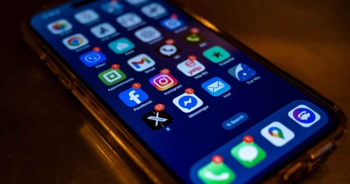 Smartphone screen displaying social media app notifications in a dimly lit setting Smartphone screen displaying social media app notifications in a dimly lit setting