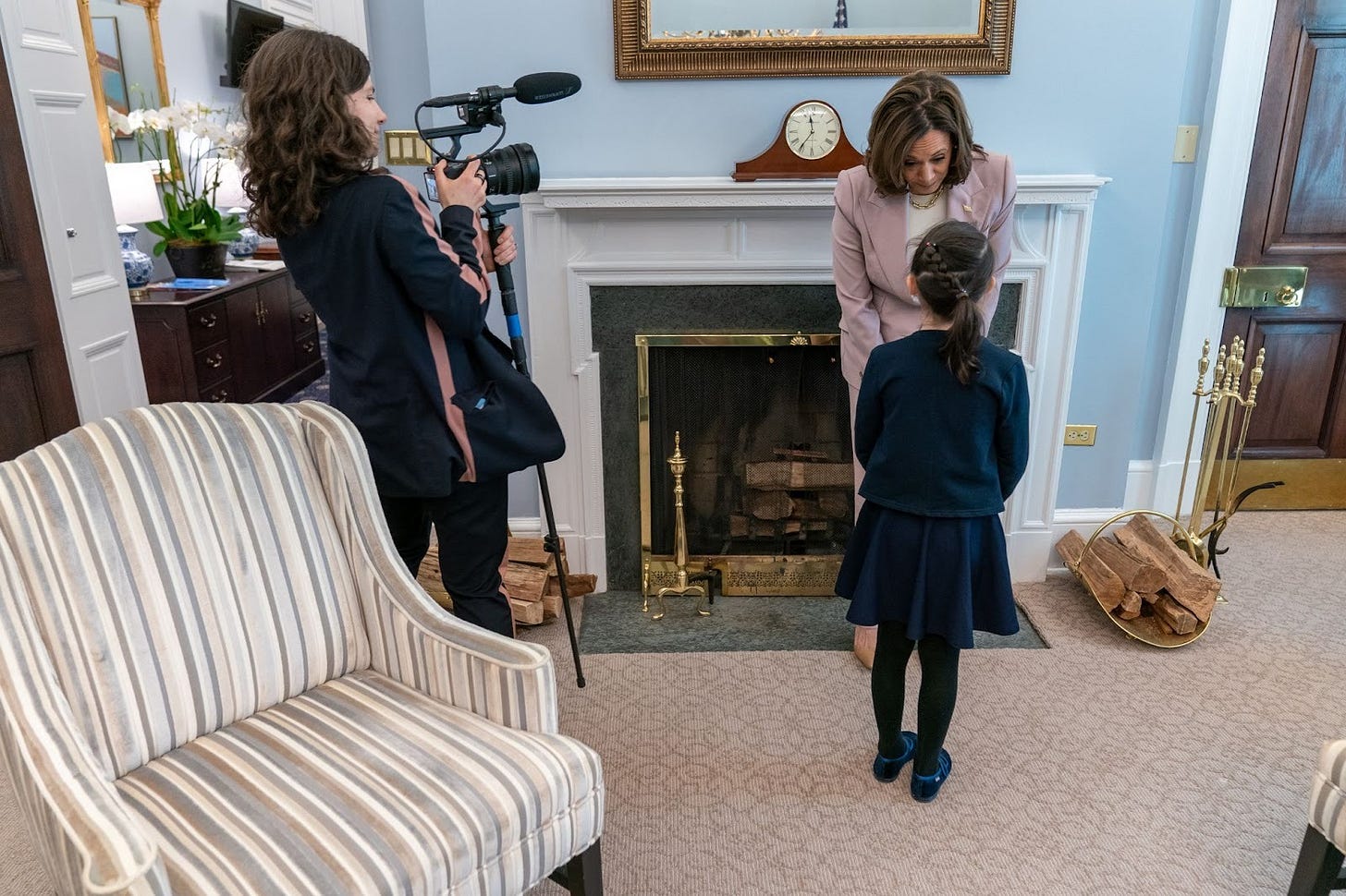 A person and a child standing in a room with a camera

AI-generated content may be incorrect.