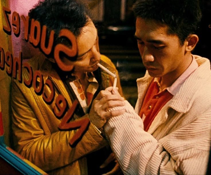 This may contain: two men standing next to each other in front of a mirror