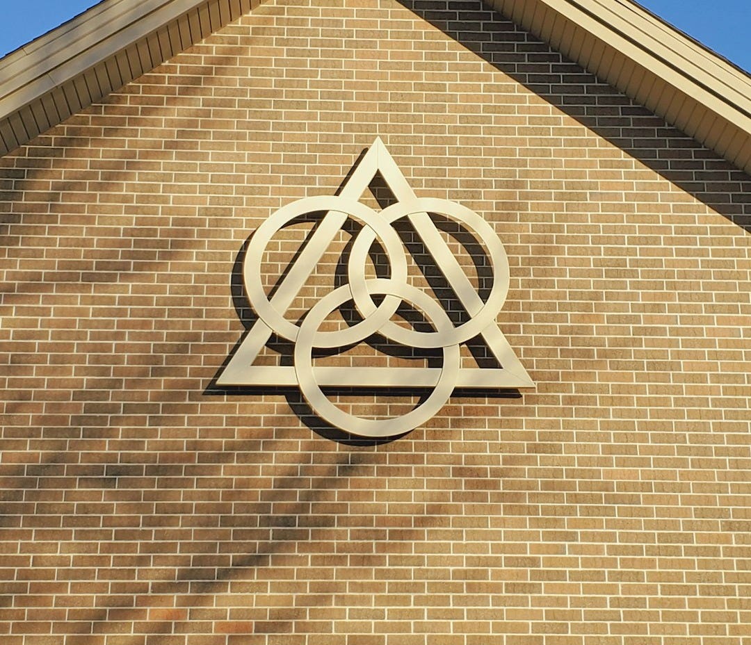 brown brick wall with white cross