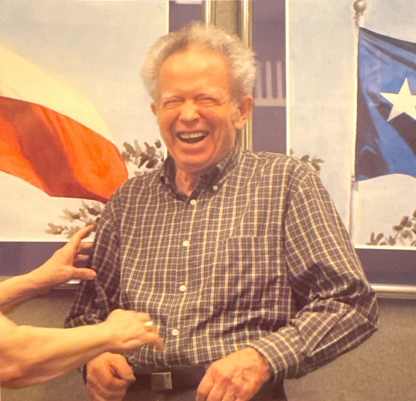 Grandpa laughing in his office as my grandmother reaches to tickle him.