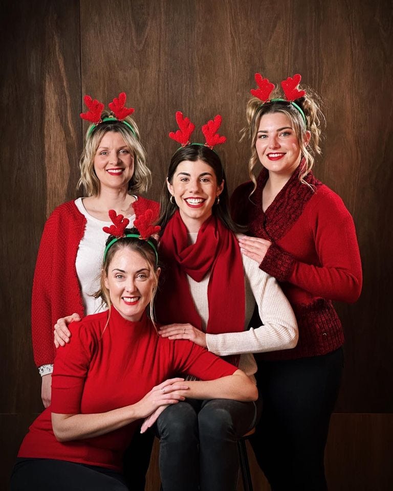 May be an image of 4 people, people standing, christmas tree and indoor