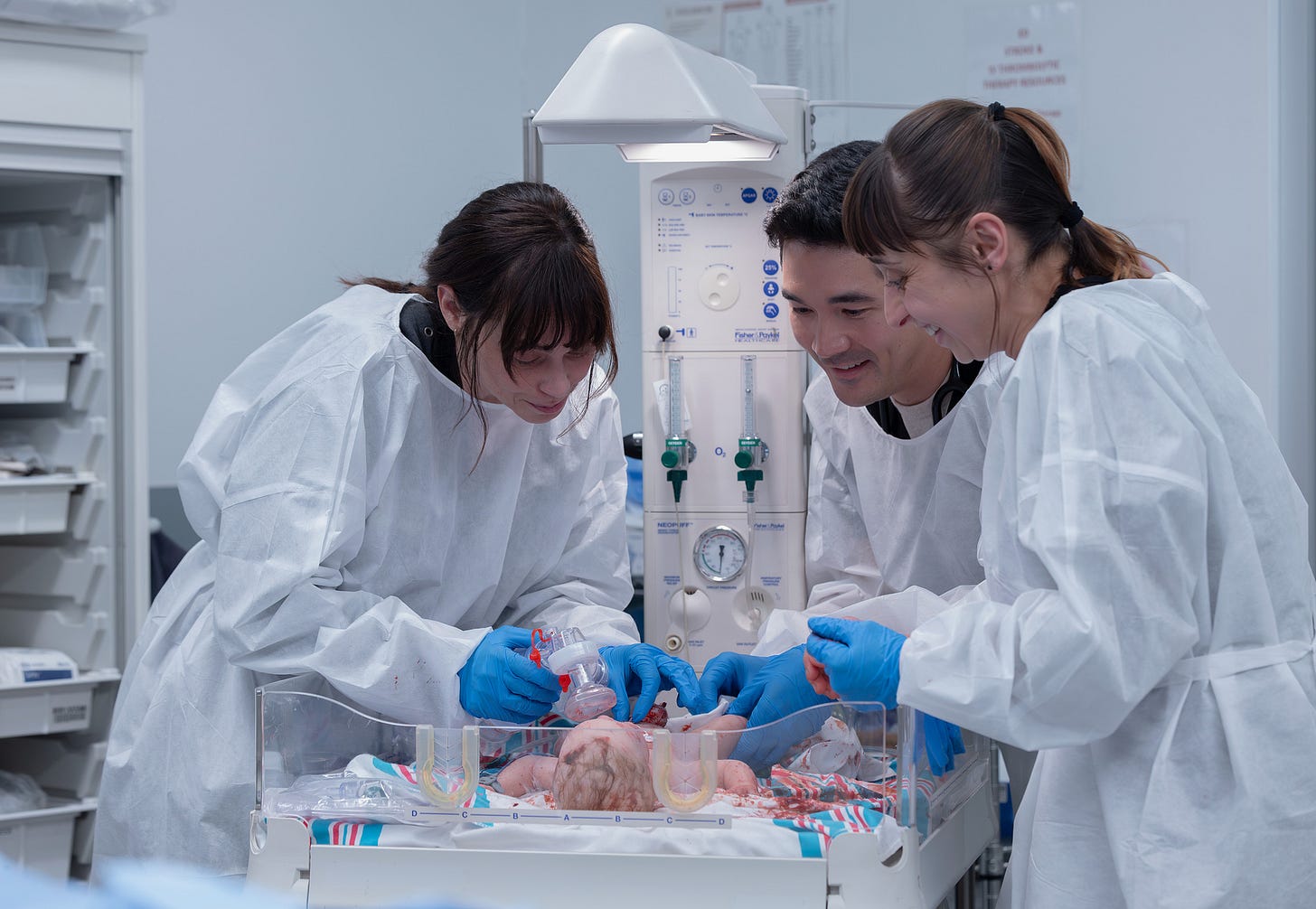 Doctors tending to a new born baby