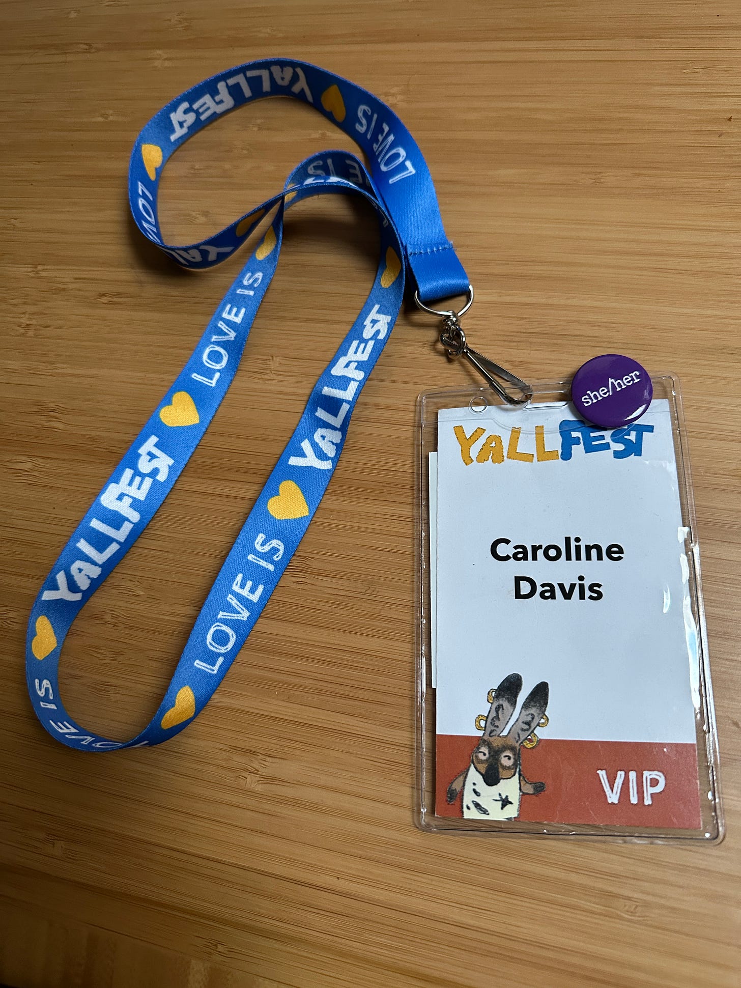 blue lanyard for Yallfest with the name Caroline Davis and VIP