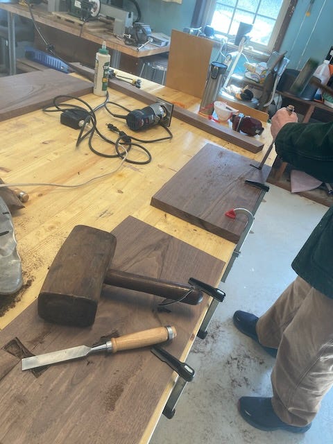 Woodworker cutting out bowtie inlay recesses. Woodworker cutting out bowtie inlay recesses.