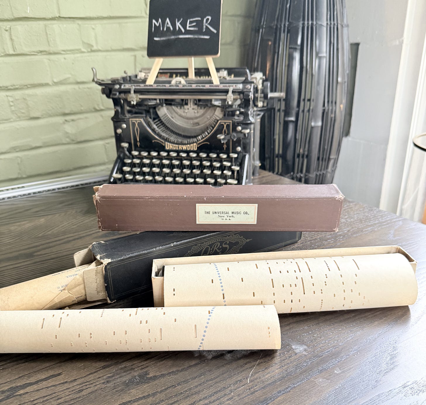 player piano rolls on a table with an antique typewriter in the background player piano rolls on a table with an antique typewriter in the background