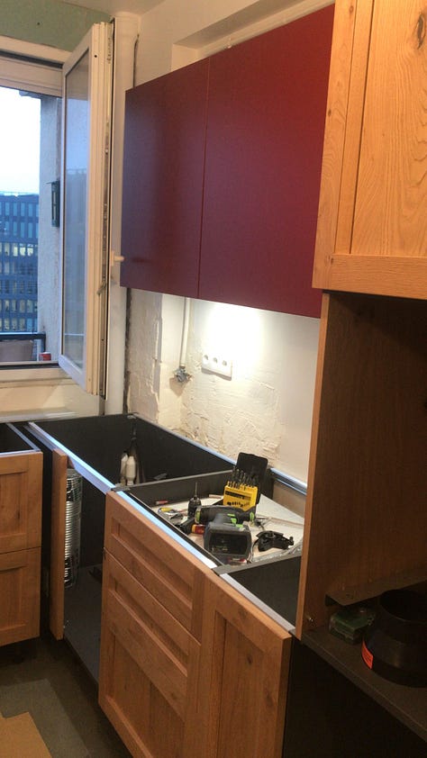 A man does DIY kitchen renovation in a Paris apartment