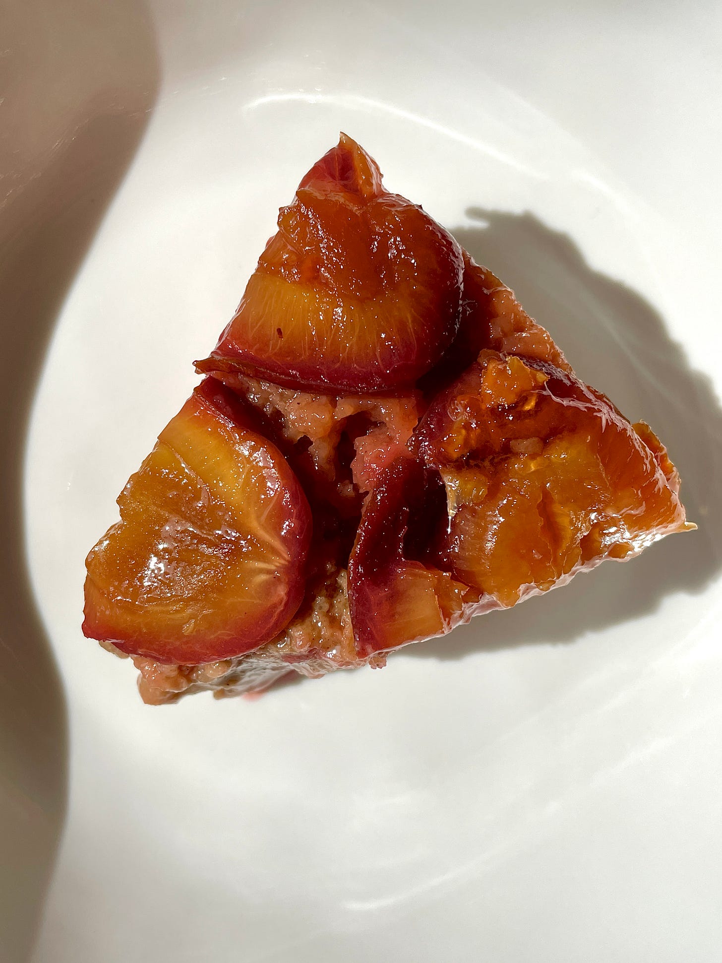 Slice of spiced plum & buttermilk upside-down cake