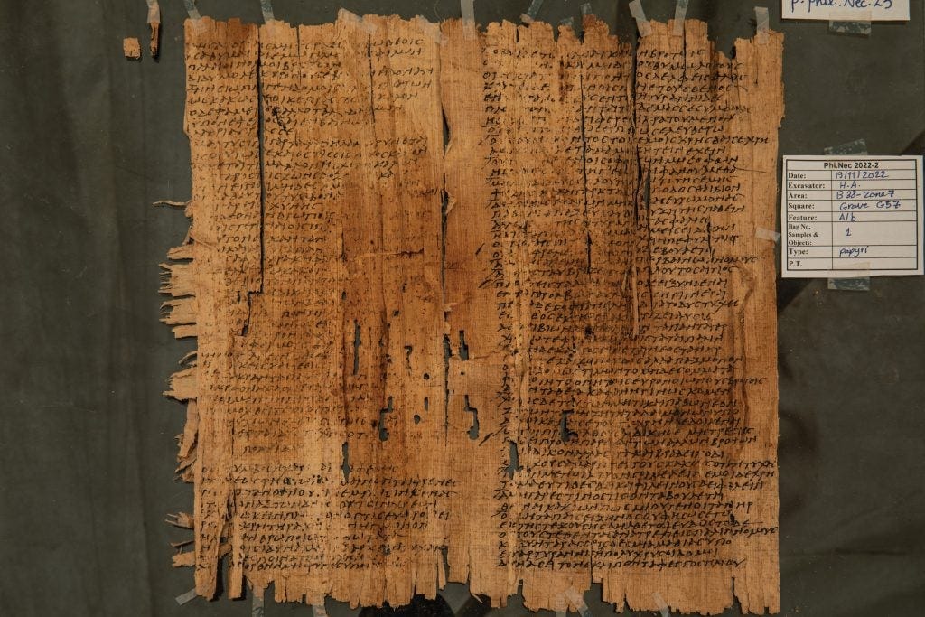 a yellowed papyrus with markings showing text in Greek