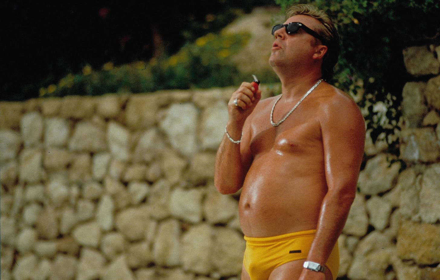 Ray Winstone smokes a cigarette in yellow swim briefs in "Sexy Beast" (2000)