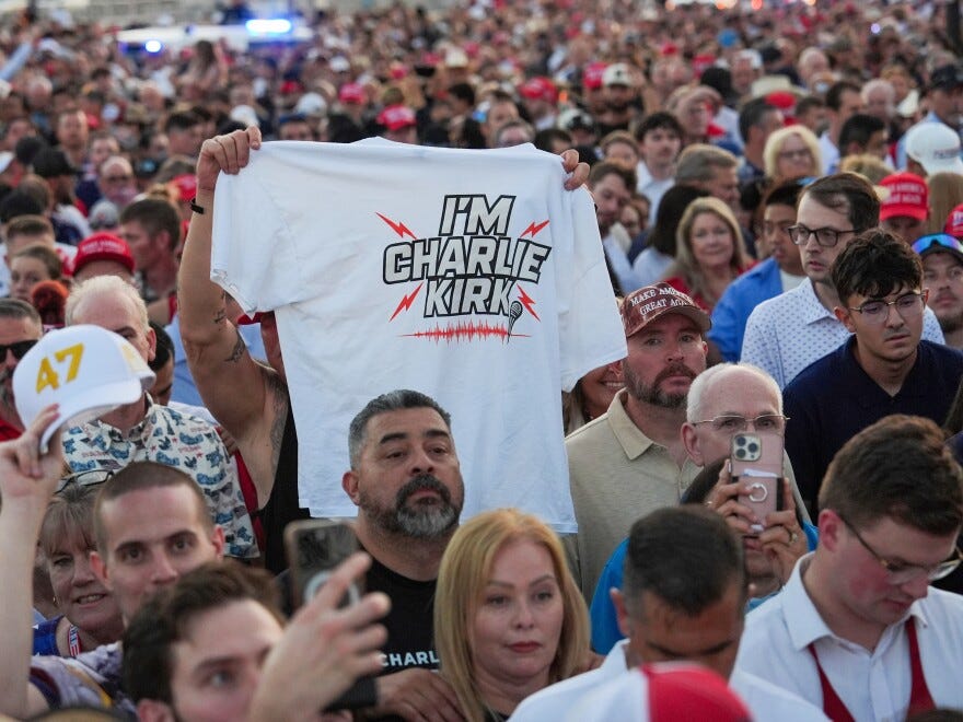 People wait in line before a memorial for conservative activist Charlie Kirk Sunday, Sept. 21, 2025, at State Farm Stadium in Glendale, Ariz.