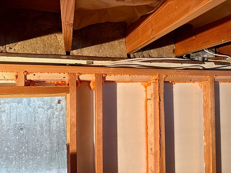 Pictures showing an open wall where drywall would be attached.