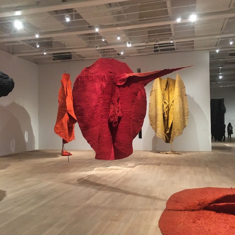 Magdalena Abakanowicz’s work: View of Invented Anatomy room showing from L-R {partially} ‘Black Ball’, 1975 / ‘Abakan Orange’, 1968 / ‘Abakan Red’, 1969 (middle) / ‘Abakan Yellow’, 1970 / ‘Abakan Orange’, 1971 (bottom right corner). Magdalena Abakanowicz’s work: View of Invented Anatomy room showing from L-R {partially} ‘Black Ball’, 1975 / ‘Abakan Orange’, 1968 / ‘Abakan Red’, 1969 (middle) / ‘Abakan Yellow’, 1970 / ‘Abakan Orange’, 1971 (bottom right corner).