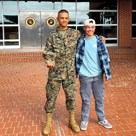 Mac in utes and boots, in dress blues, and in the civvies in the rea seat of the car