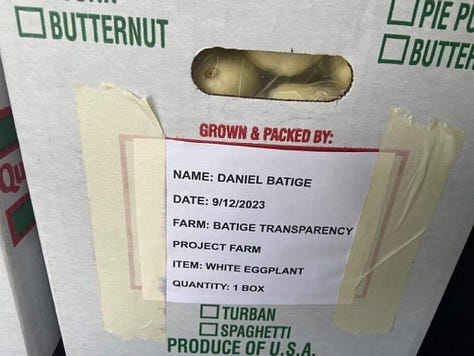 A box filled with white eggplant with a sign taped on it with information about the produce. A man loading boxes of produce in a van. A stack of boxes sitting on top of a pallet.