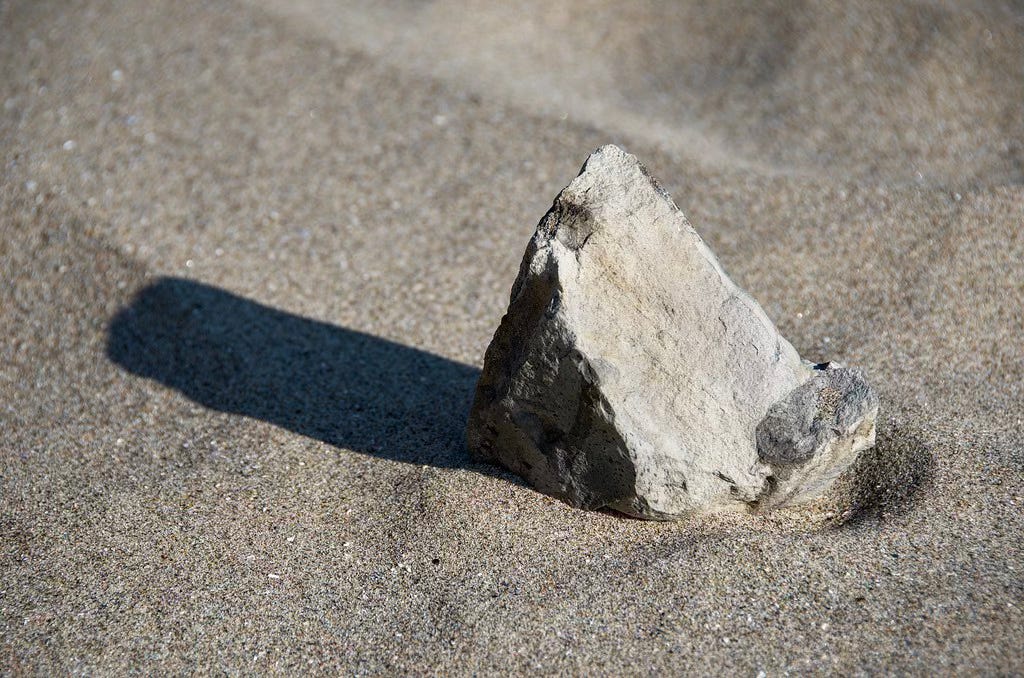 Stone standing in the stand, casting a long shadow to the left. Stone standing in the stand, casting a long shadow to the left.