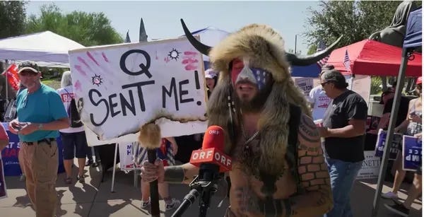 Qanon Shaman holding Q Sent Me sign Qanon Shaman holding Q Sent Me sign