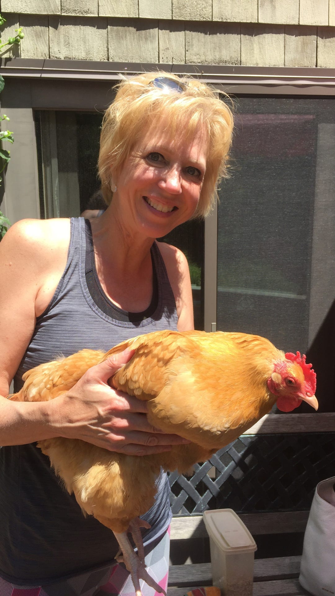 Woman holding brown chicken