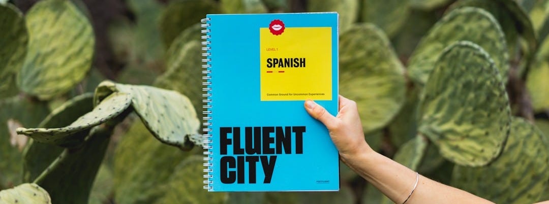 person holding Fluent City book