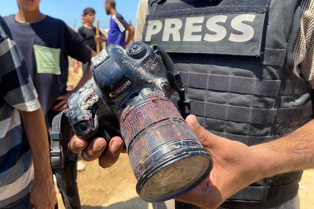 A journalist holds the blood-covered camera belonging to Palestinian photojournalist Mariam Dagga, who freelanced for The Associated Press and was killed in an Israeli strike on Nasser Hospital in Khan Younis, in the southern Gaza Strip, Monday. A journalist holds the blood-covered camera belonging to Palestinian photojournalist Mariam Dagga, who freelanced for The Associated Press and was killed in an Israeli strike on Nasser Hospital in Khan Younis, in the southern Gaza Strip, Monday.