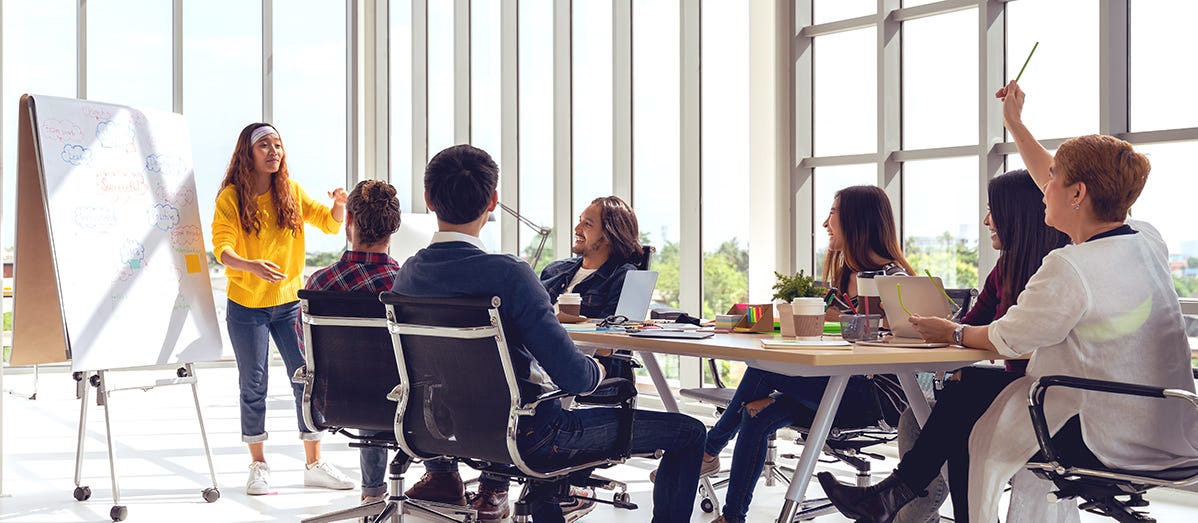 A group of people sitting around a table

Description automatically generated with medium confidence